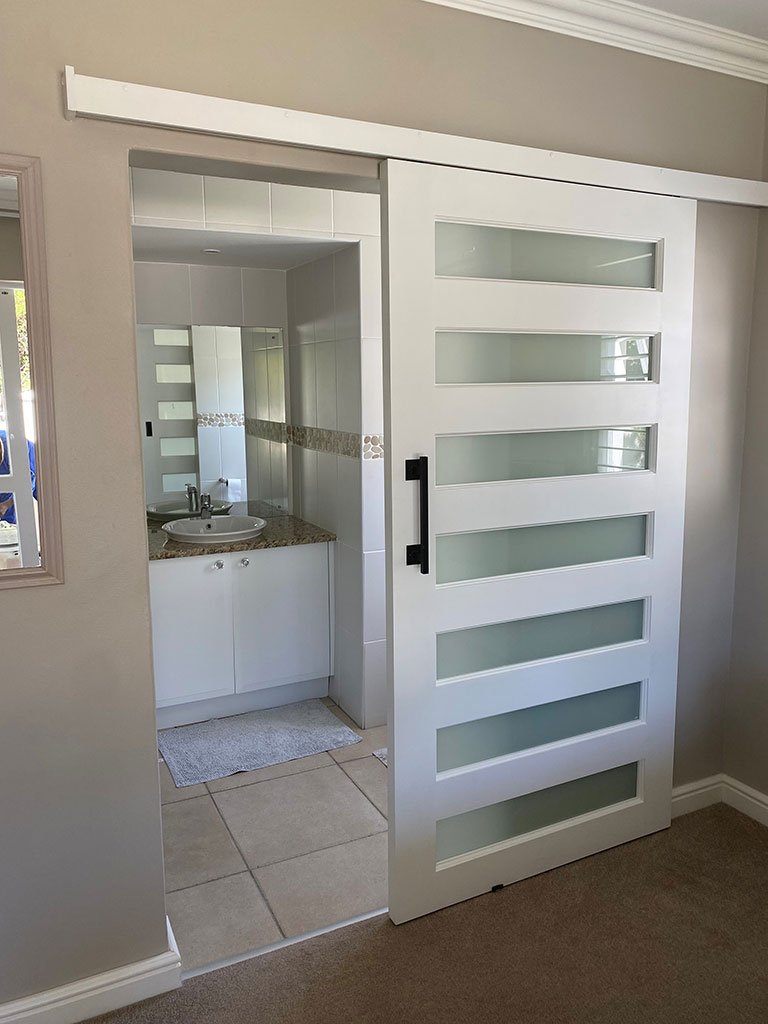Modern white barn door with frosted glass banding