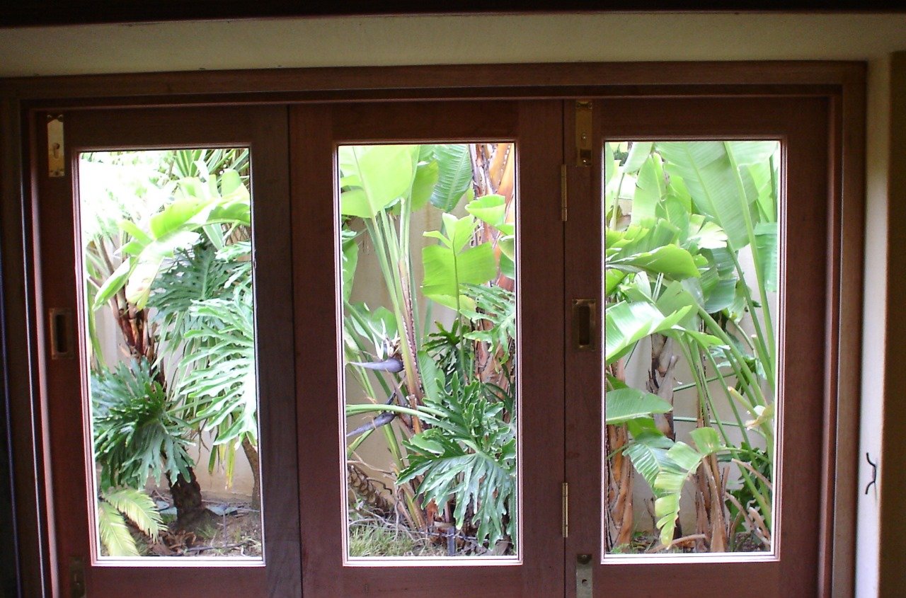 Folding doors opening onto lush tropical planting
