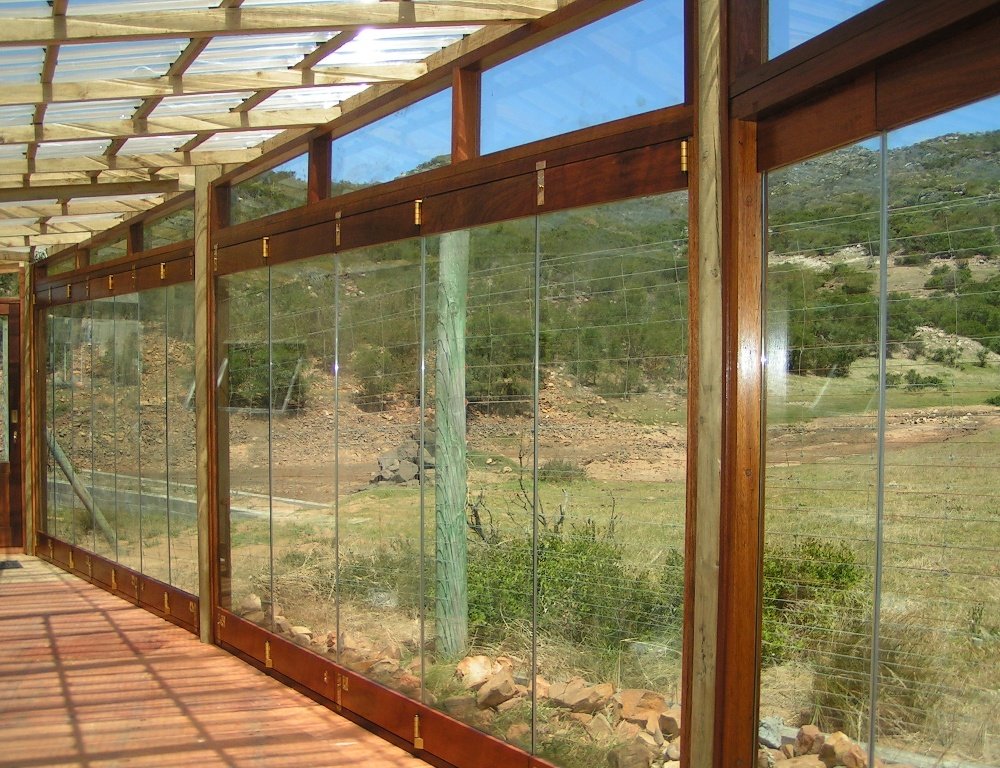 Timber-framed glass conservatory with sweeping hillside views