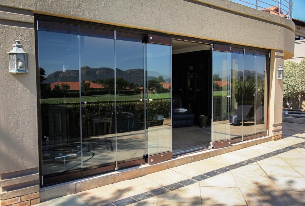 Dark-framed glass enclosure looking out over mountains