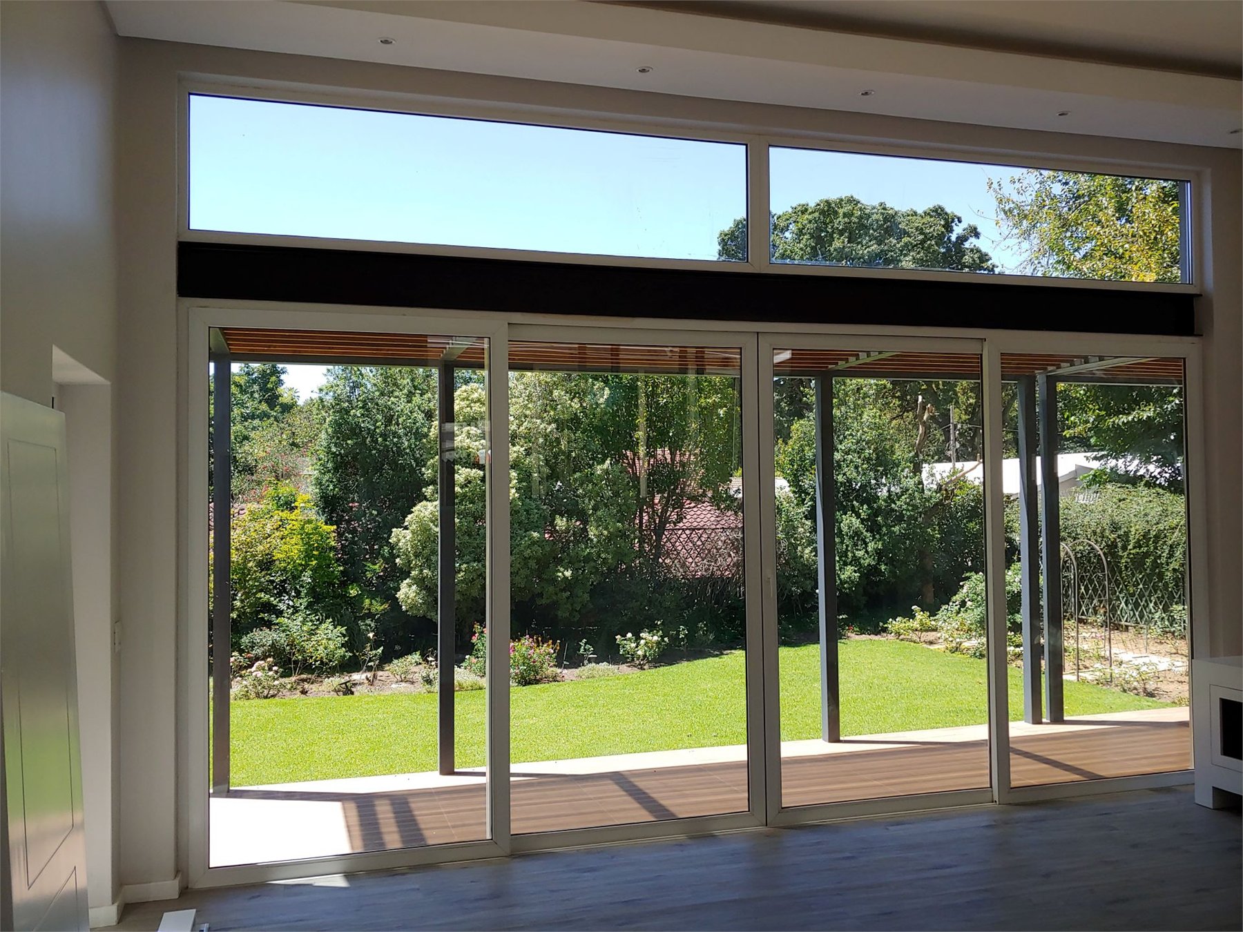 Wide sliding glazed doors opening onto a landscaped garden