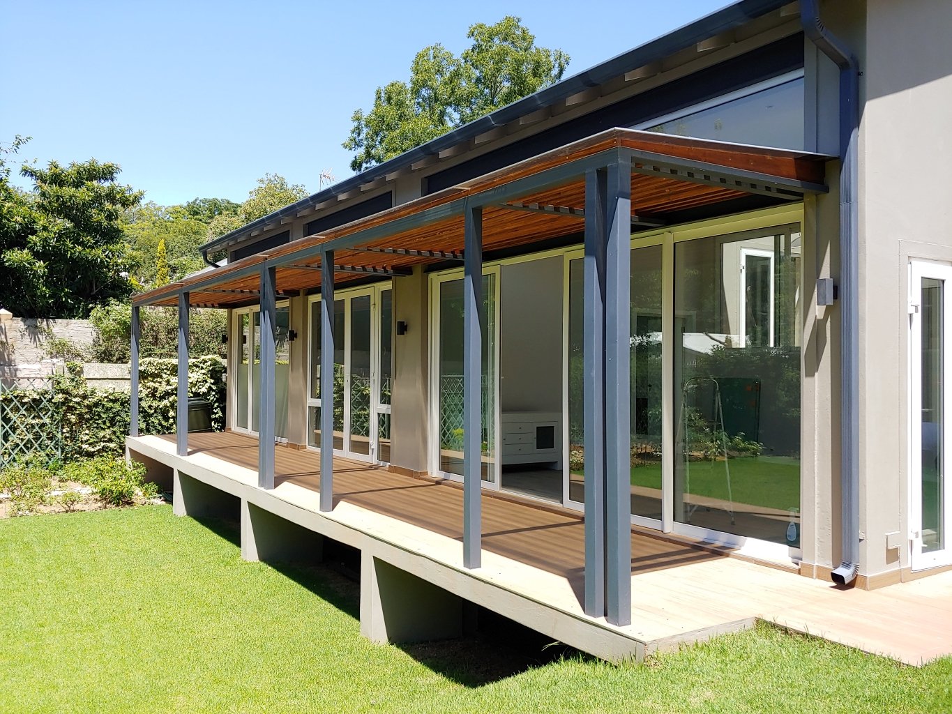 Covered veranda glazed in uPVC with slim blue-grey framing