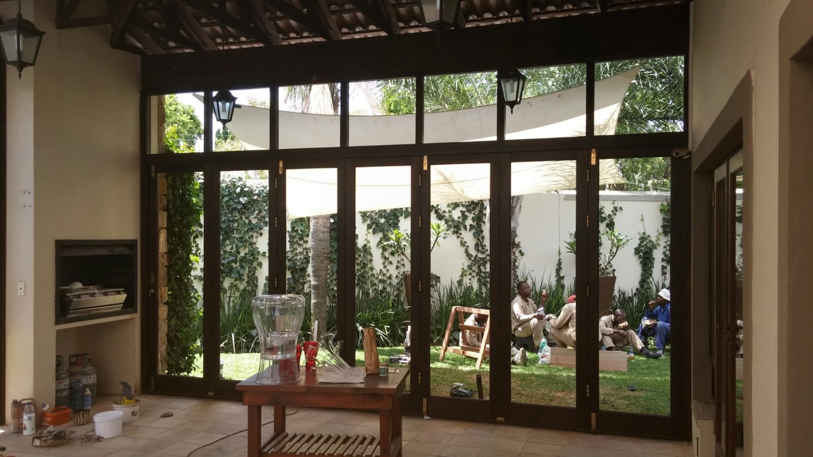 Enclosed patio with dark woodgrain uPVC framing